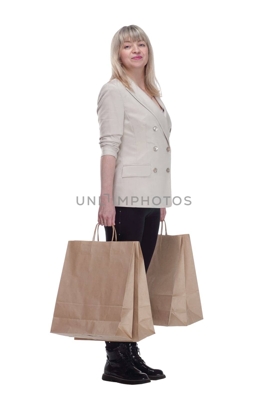 in full growth. smiling blonde woman with shopping bags . isolated on a white background.