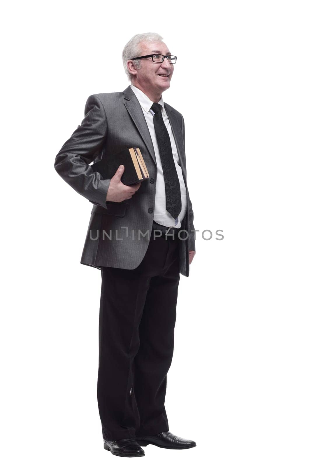 in full growth. smiling business man with a stack of books. isolated on a white background.