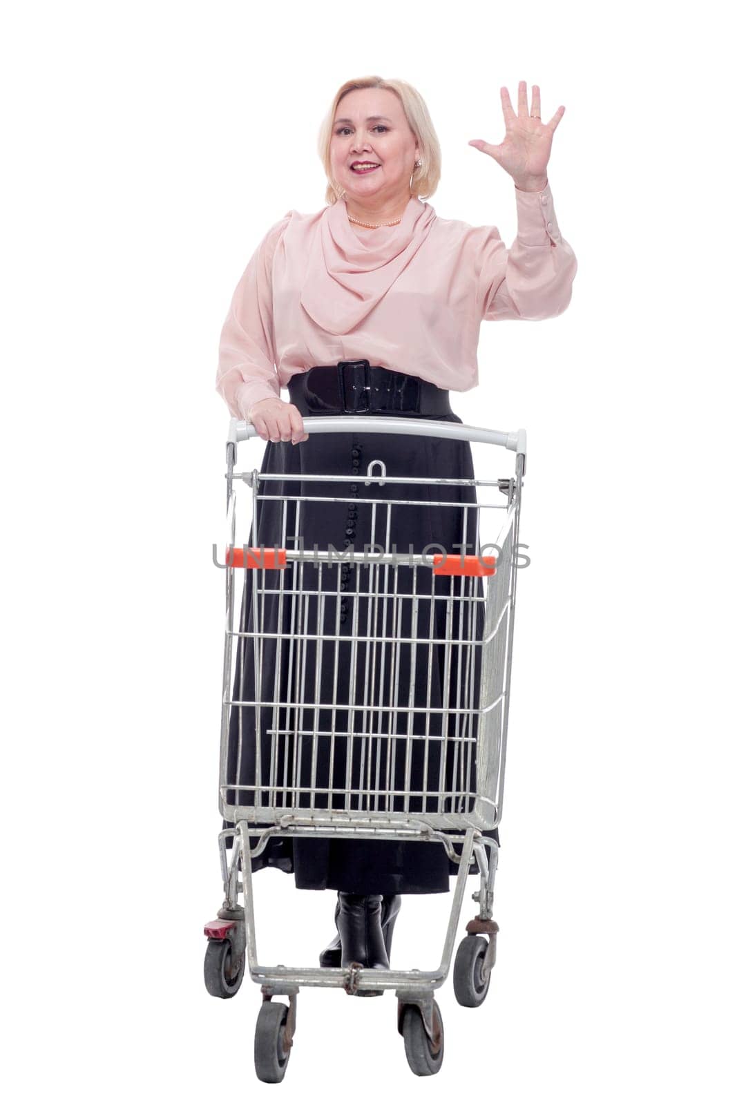 standing young woman with empty shopping cart smiling at camera