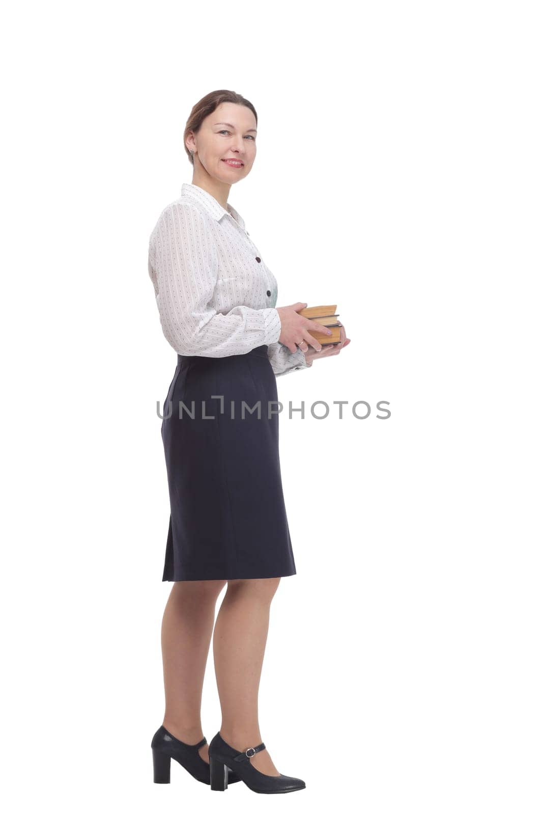 in full growth. businesswoman with a stack of books. isolated on a white background.