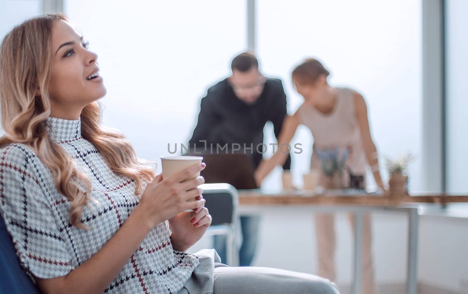 young business woman with a Cup of coffee in a modern office. office weekdays