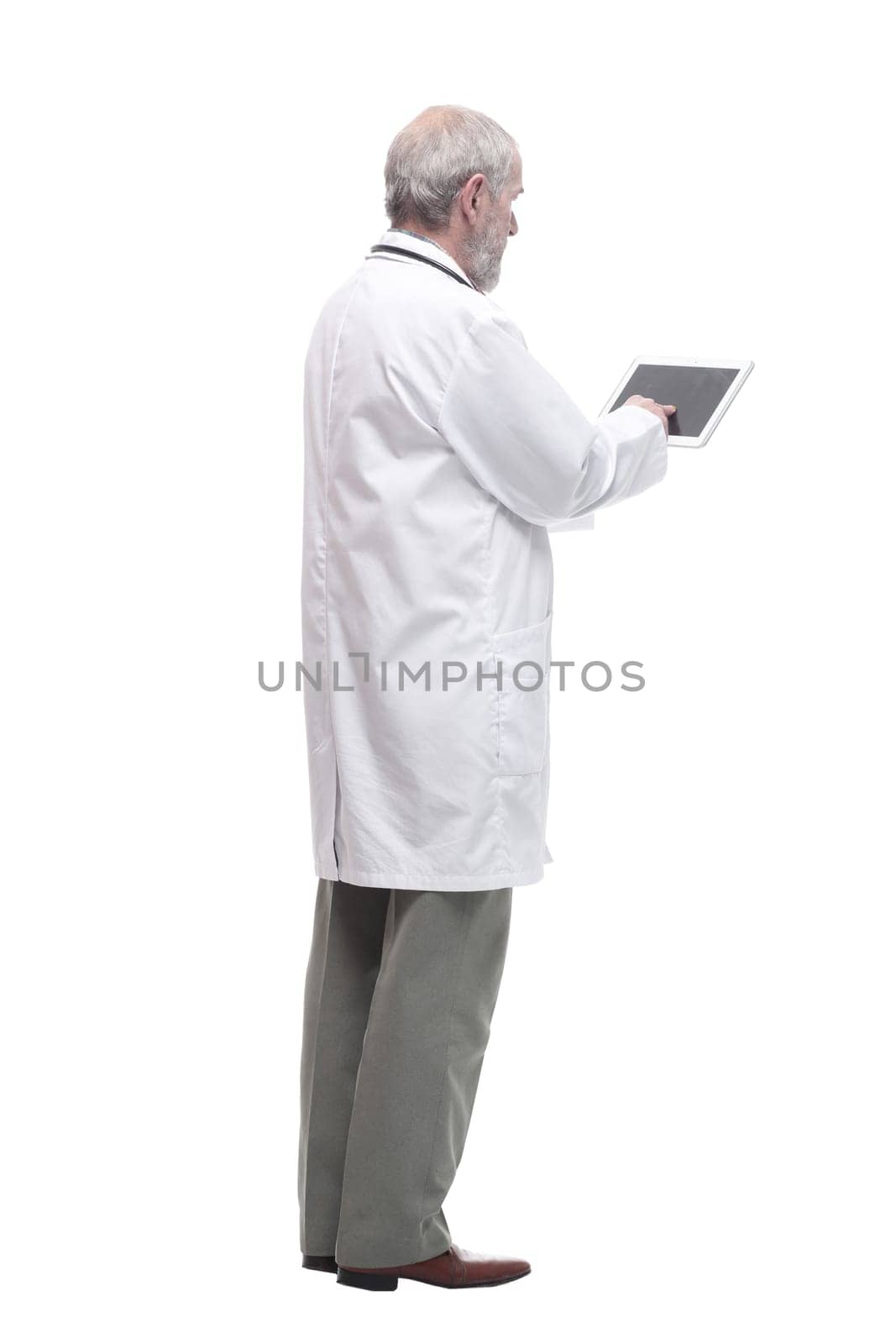 elderly competent doctor with a digital tablet. isolated on a white background.