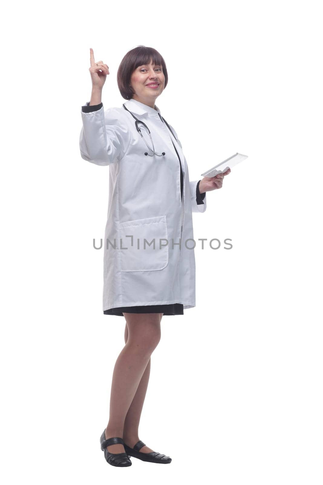 in full growth. female doctor using a digital tablet . isolated on a white background.