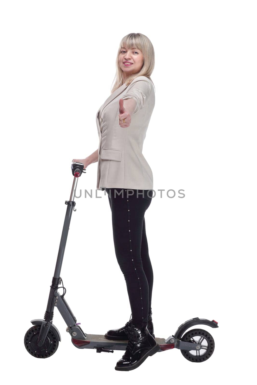 side view.happy adult woman with electric scooter looking at you . isolated on a white background.