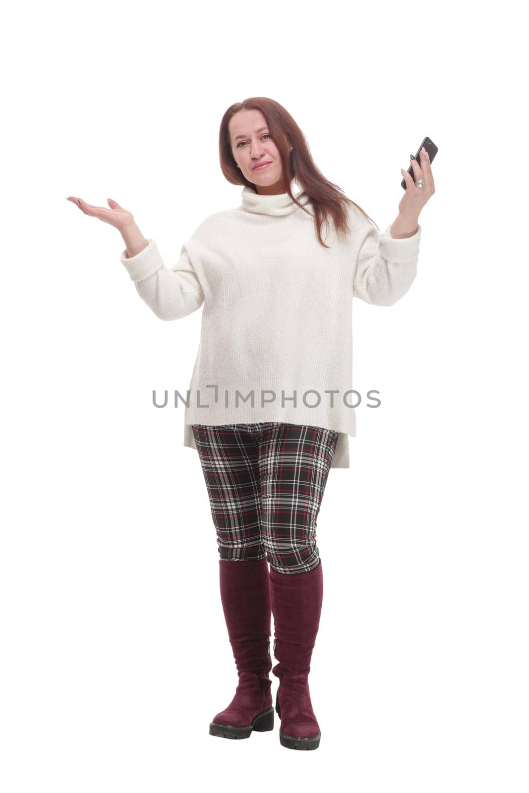 in full growth. attractive casual woman with a smartphone .isolated on a white background.
