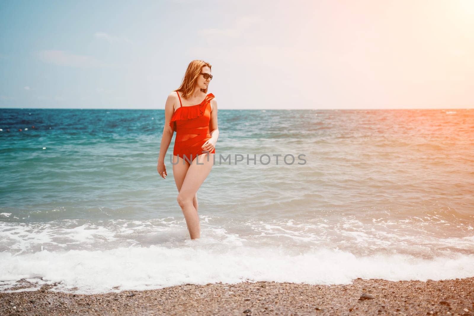 Happy loving family mother and daughter having fun together on the beach. Mum playing with her kid in holiday vacation next to the ocean - Family lifestyle and love concept.