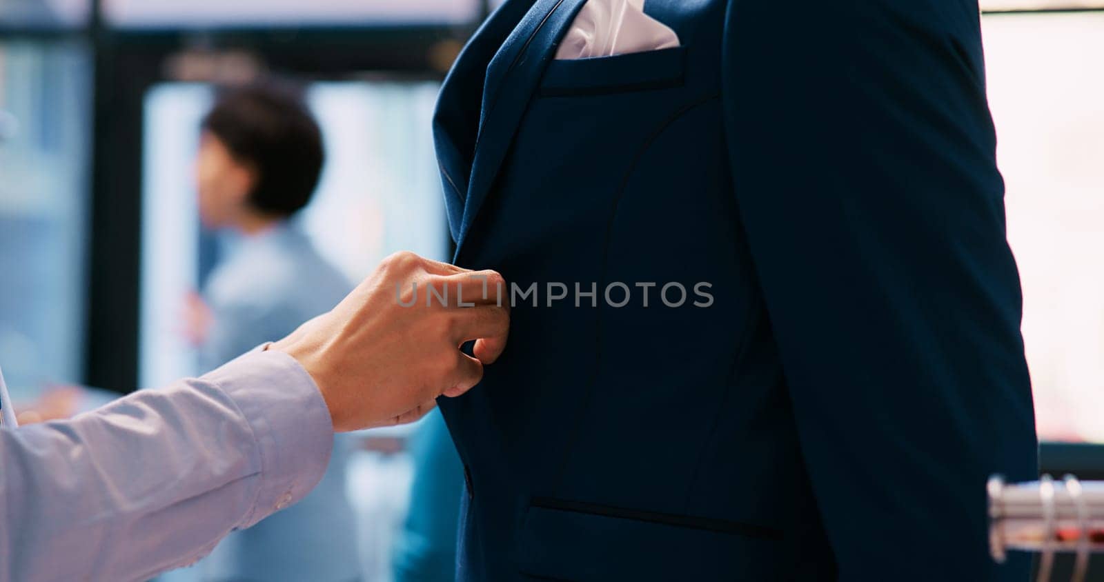 Worker arranging elegant suit by DCStudio