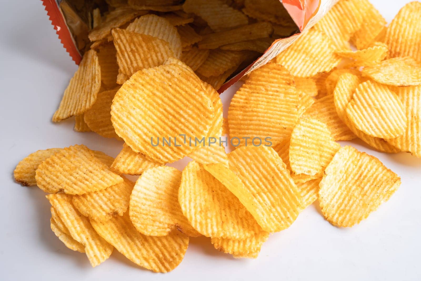 Potato chips, delicious BBQ seasoning spicy for crips, thin slice deep fried snack fast food in open bag.