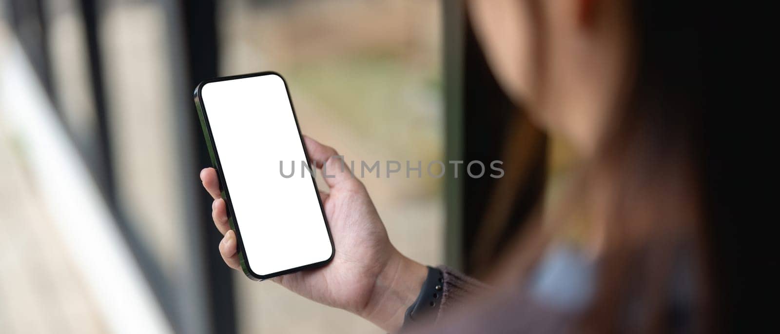 Female using smartphone blank screen display frameless. Gadget mockup design.