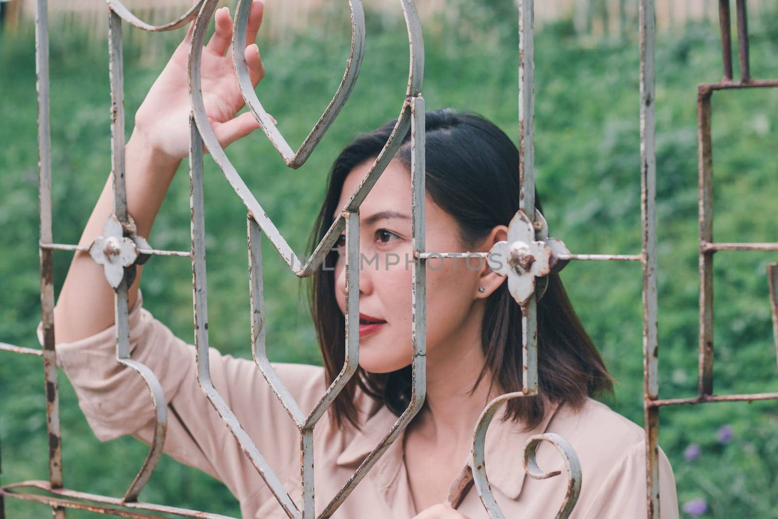 Women look out And standing holding steel mesh