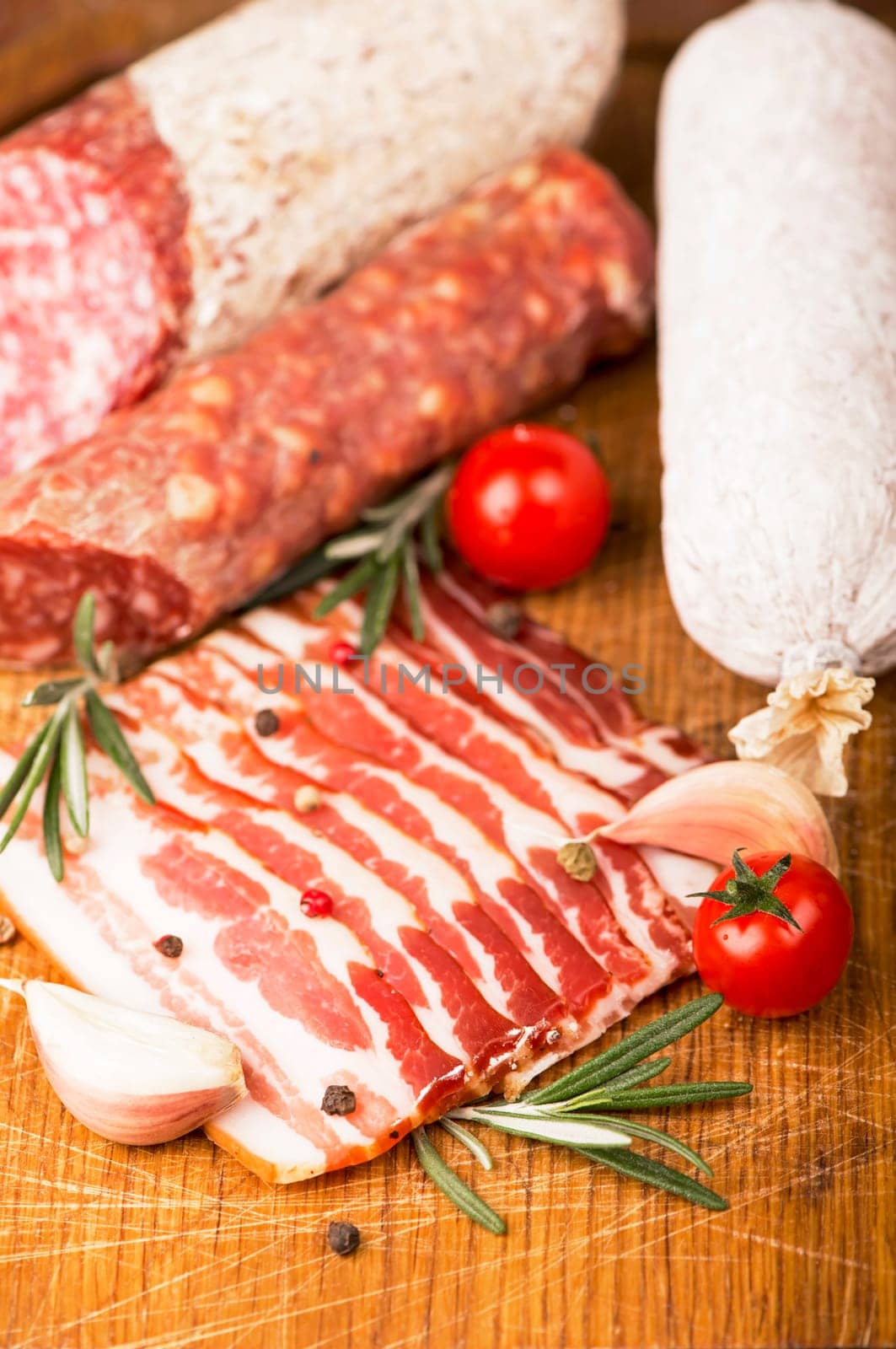 Various Smoked sausage with rosemary and peppercorns tomatoes and garlic by aprilphoto