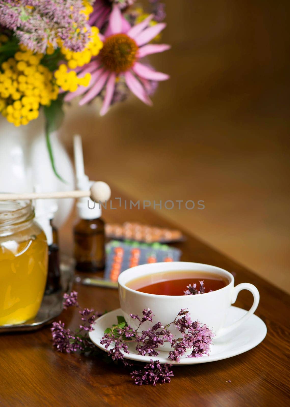 Still life from medicinal herbs, honey, herbal tea and medicines by aprilphoto