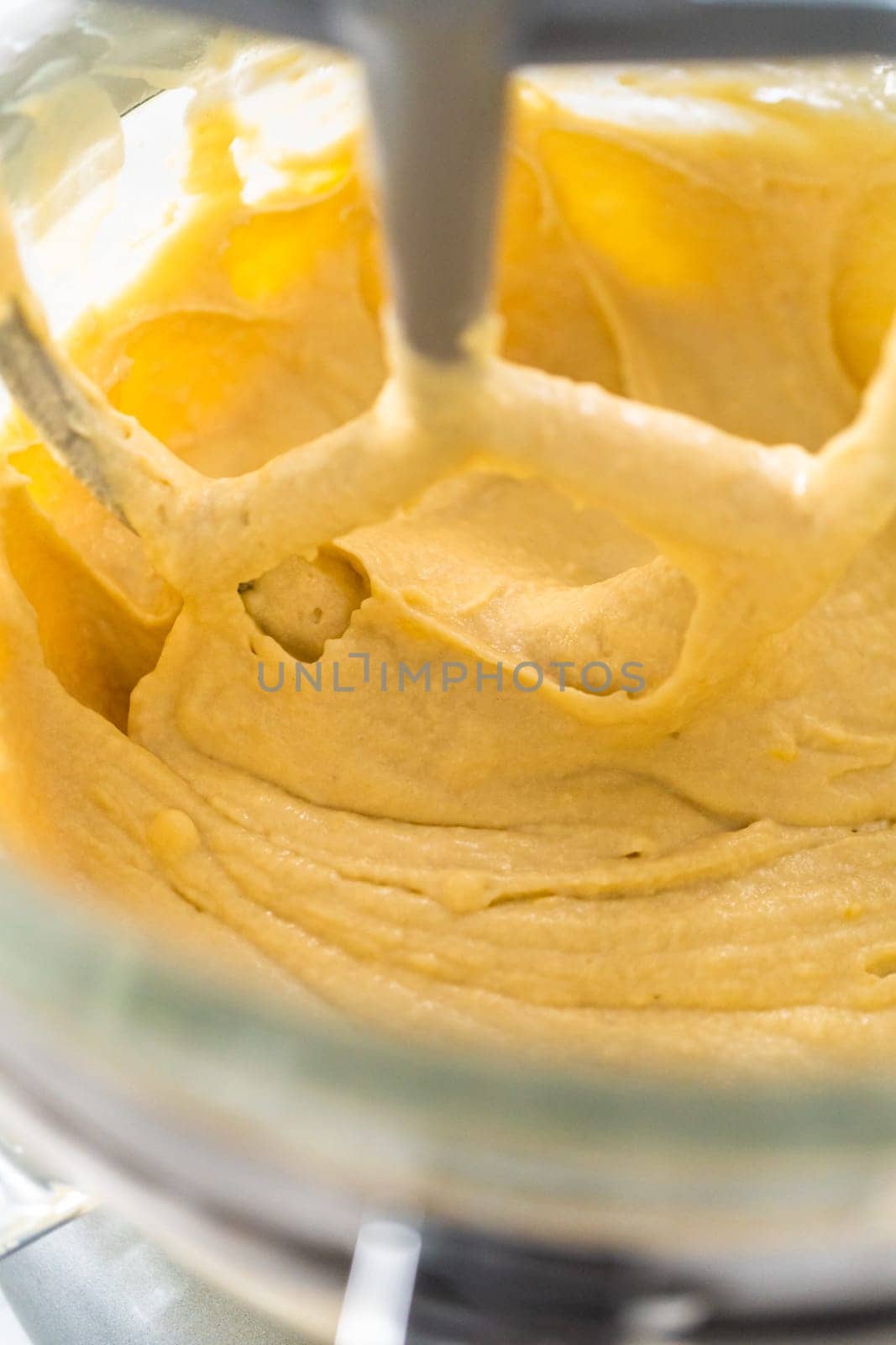 Mixing ingredients in kitchen mixer to bake mini Easter bread kulich.