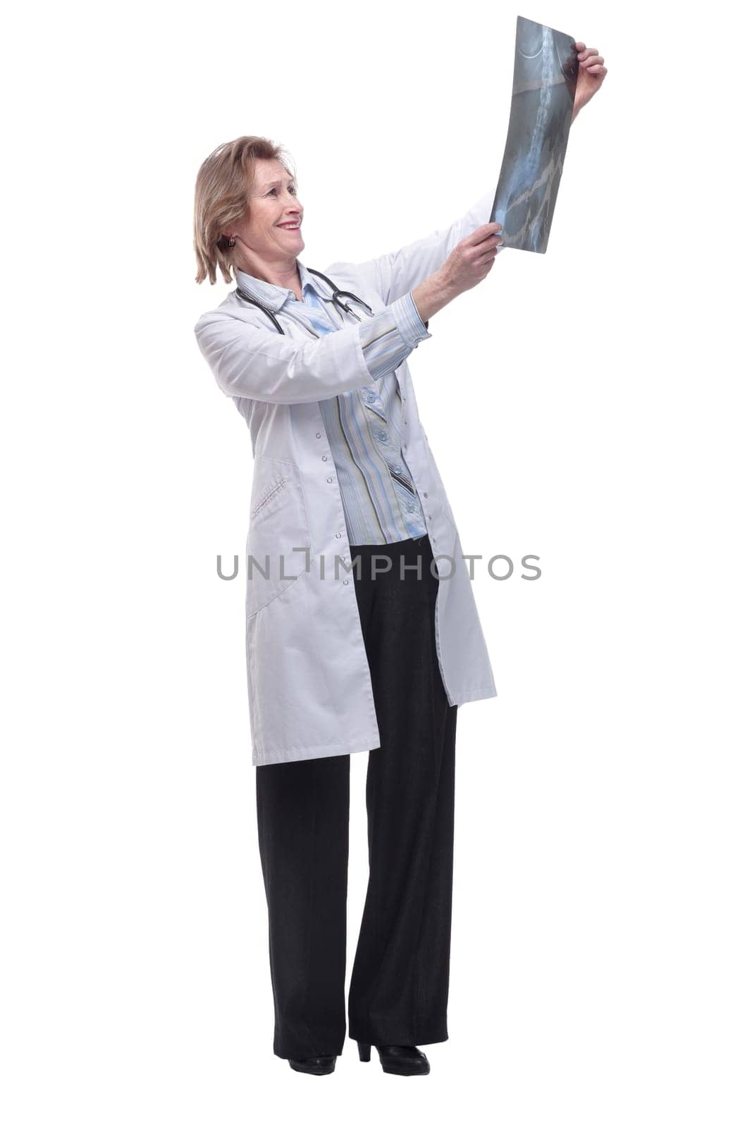 Medical doctor analysing x-ray image looking at camera and smiling by asdf