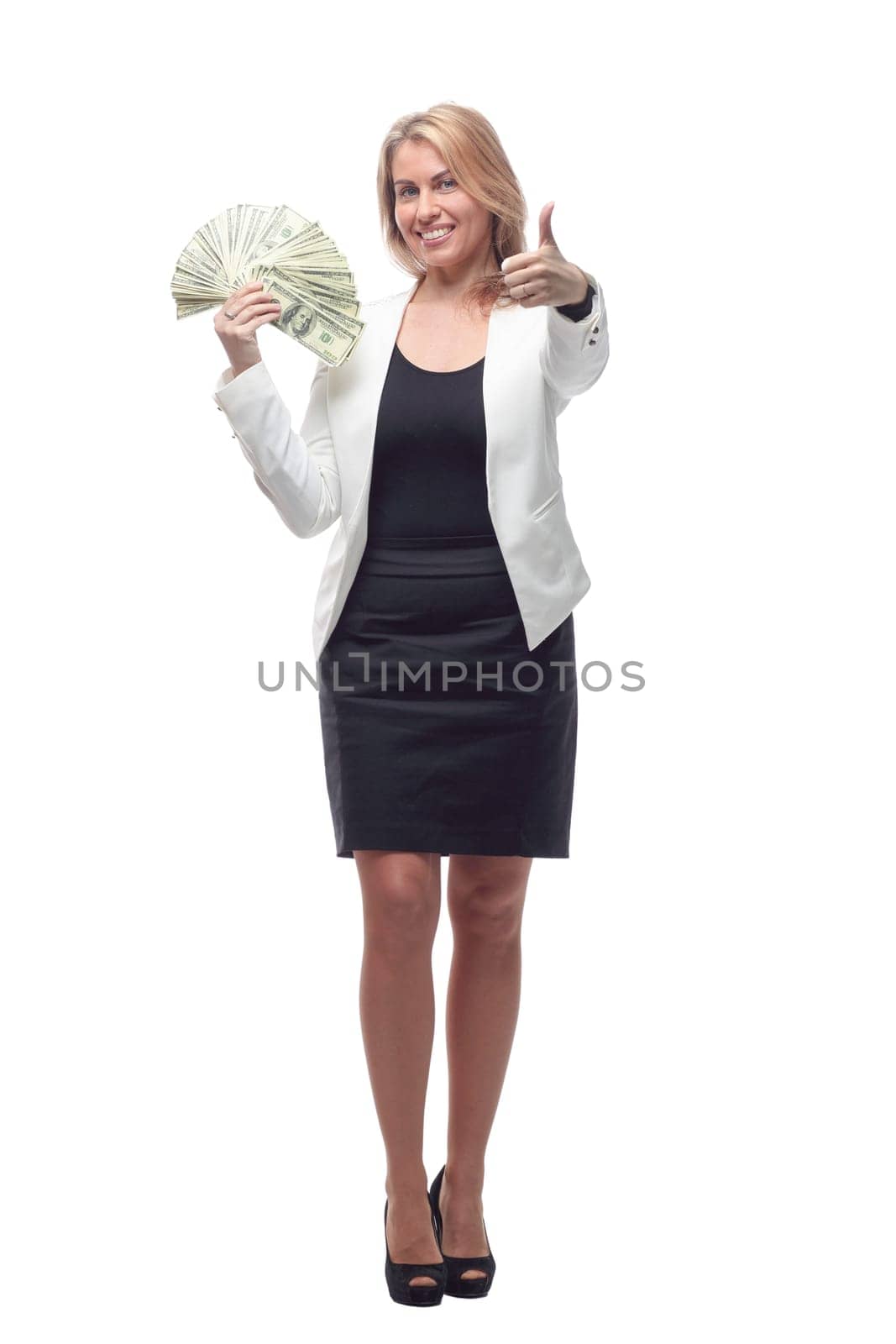 in full growth. businesswoman with a large wad of bills. isolated on a white background.