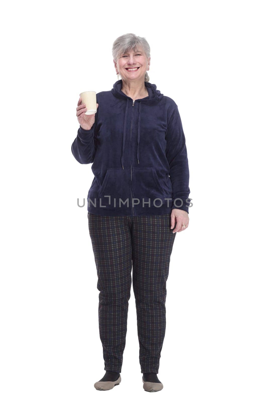 in full growth. contented old woman with a takeaway coffee . isolated on a white background.