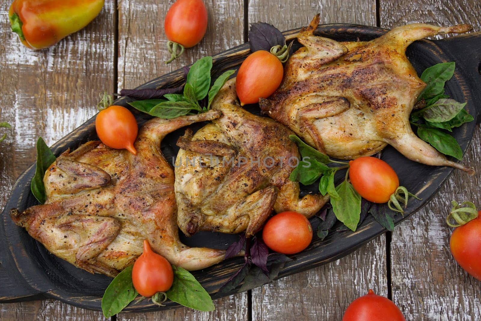 Freshly grilled quail. Fresh vegetables. Food photos.