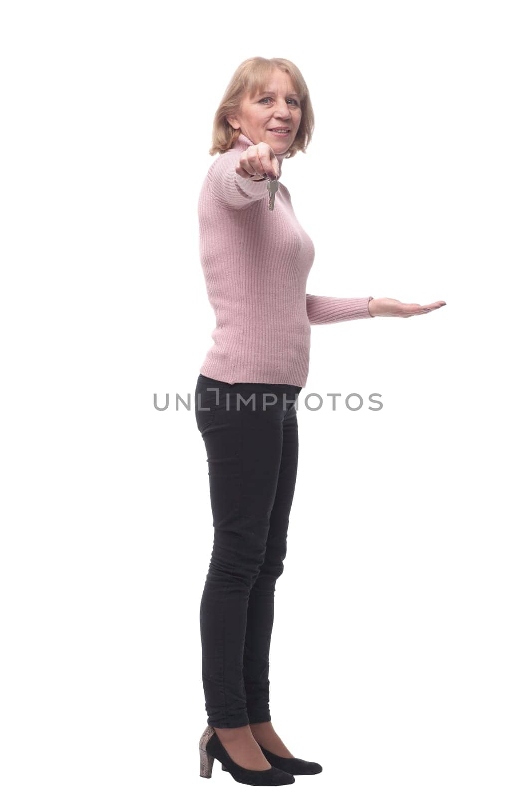 Side view of happy smiling business woman or real estate agent showing keys from new house, isolated over white background