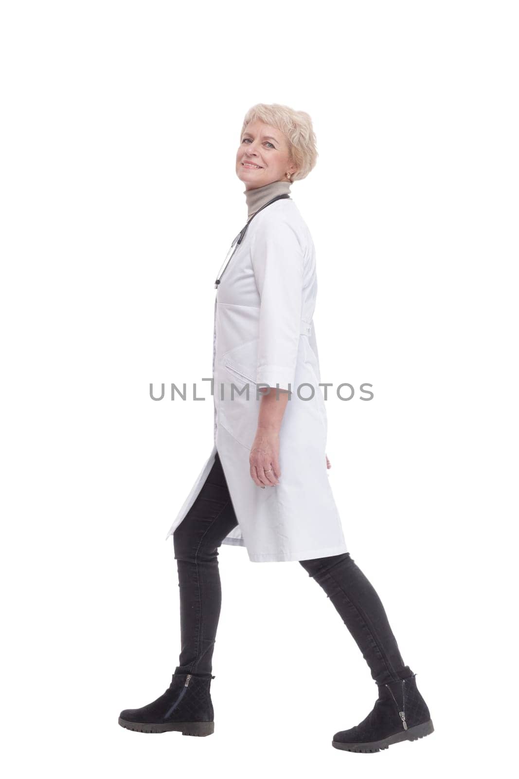 responsible female doctor with a stethoscope striding forward. isolated on a white background.