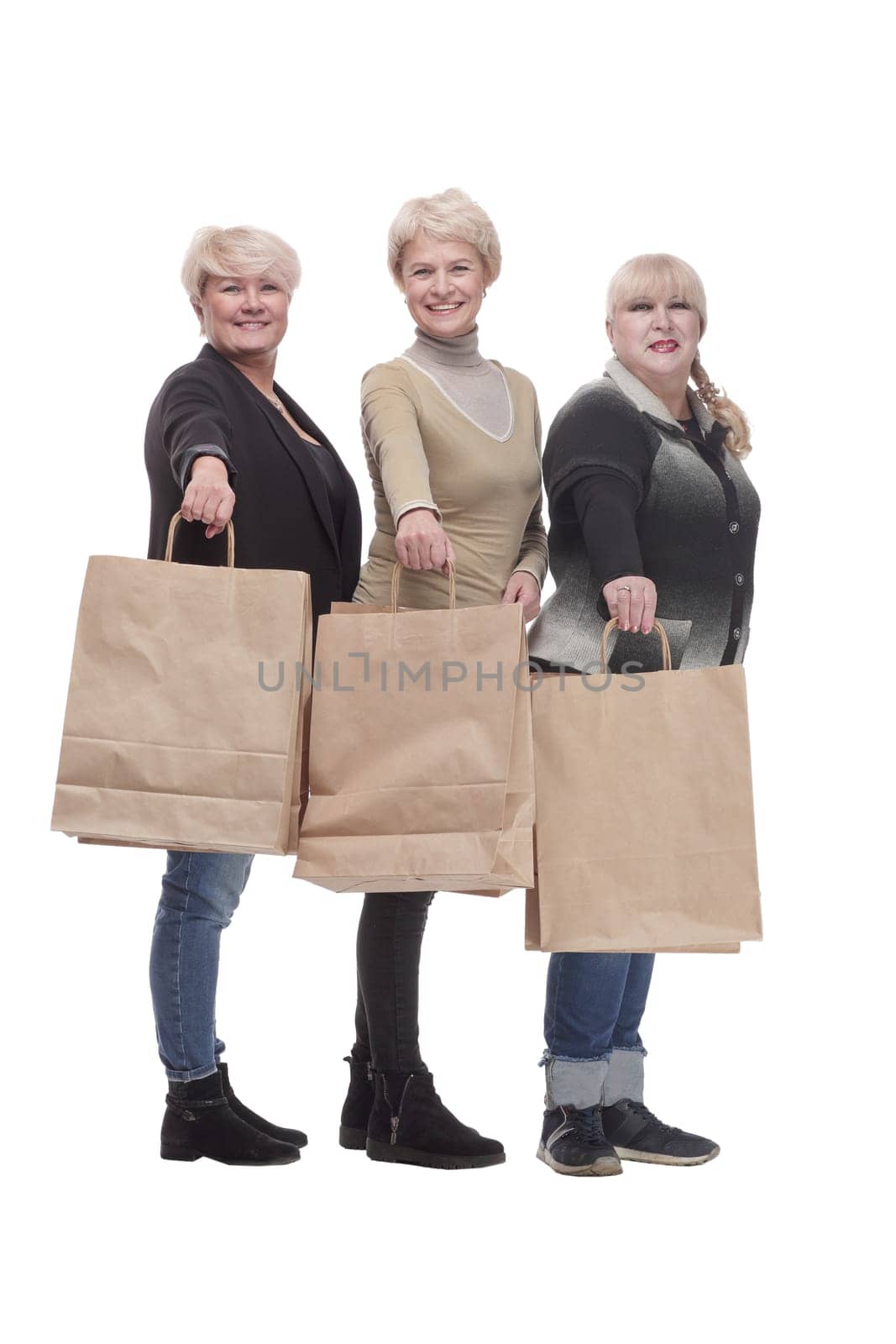 in full growth. three happy women with shopping bags. by asdf