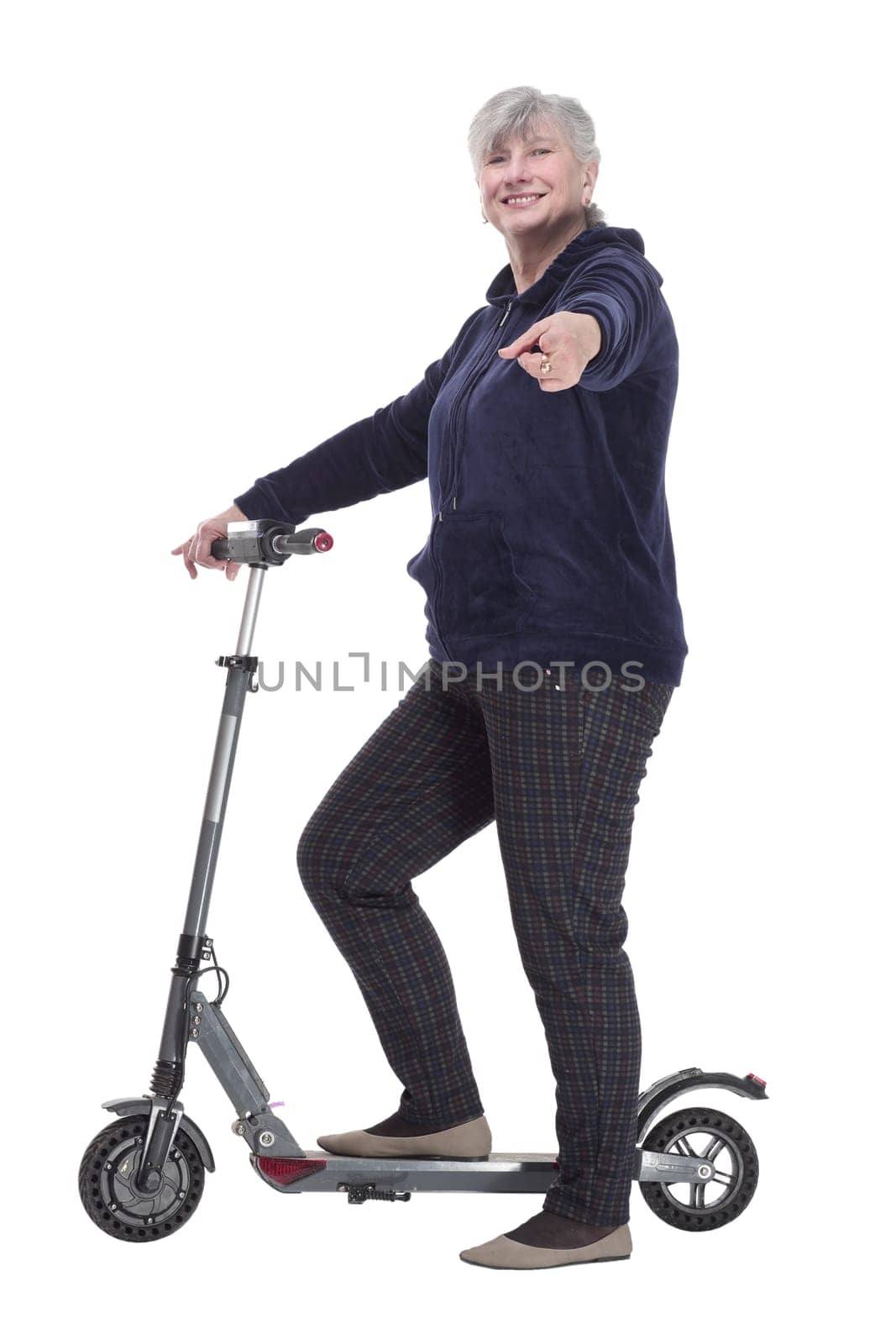 side view. smiling elderly woman with an electric scooter looking at you . isolated on a white background.