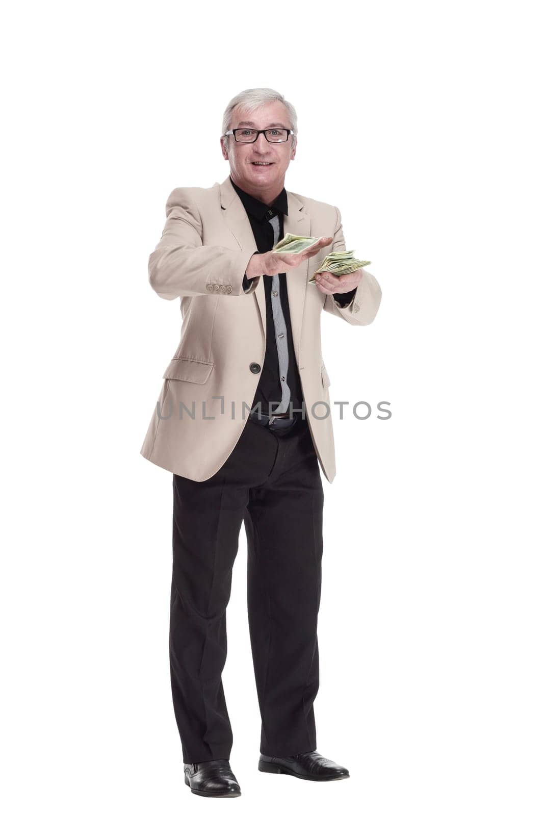 in full growth. happy intelligent man with banknotes. isolated on a white background.