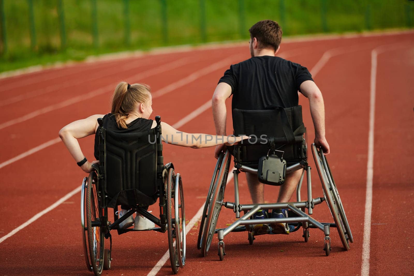 An inspiring couple with disability showcase their incredible determination and strength as they train together for the Paralympics pushing their wheelchairs in marathon track.