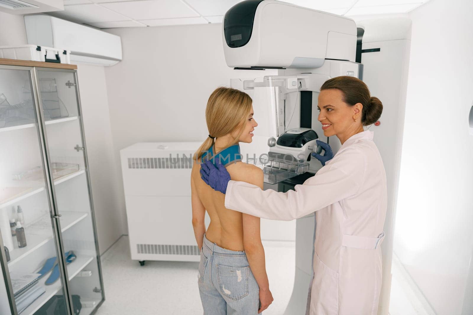 Female radiologist doing mammogram x ray for woman to check for breast cancer. High quality photo