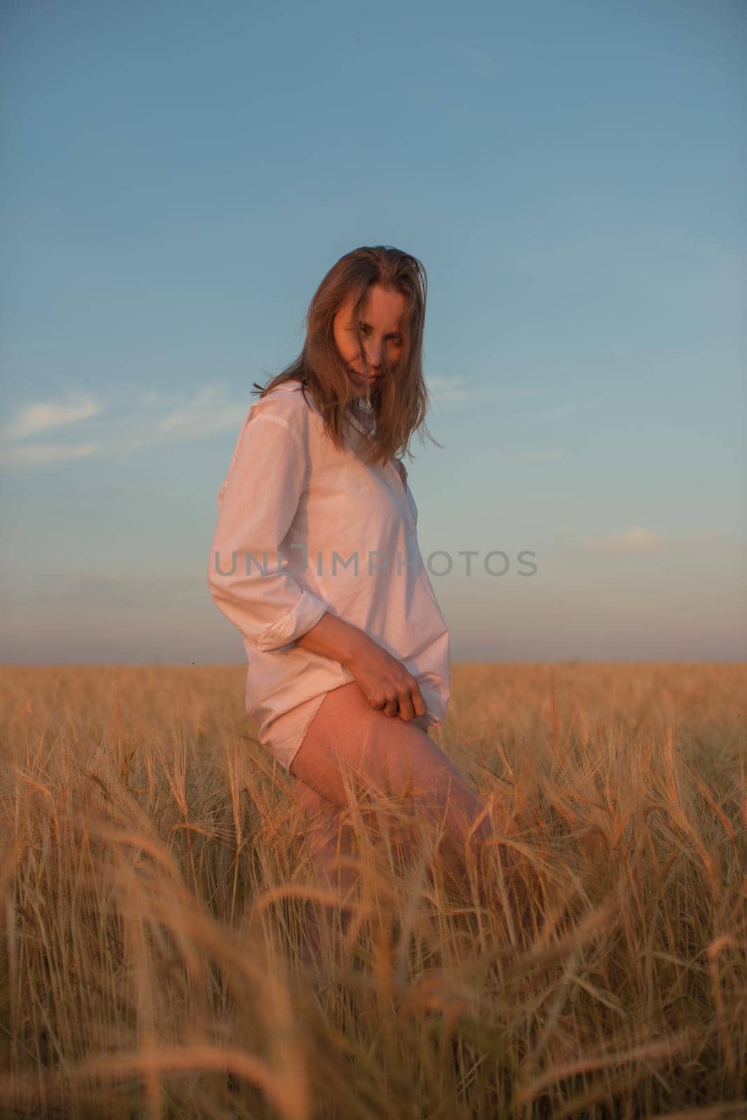 Woman in the yellow field of wheat by rusak