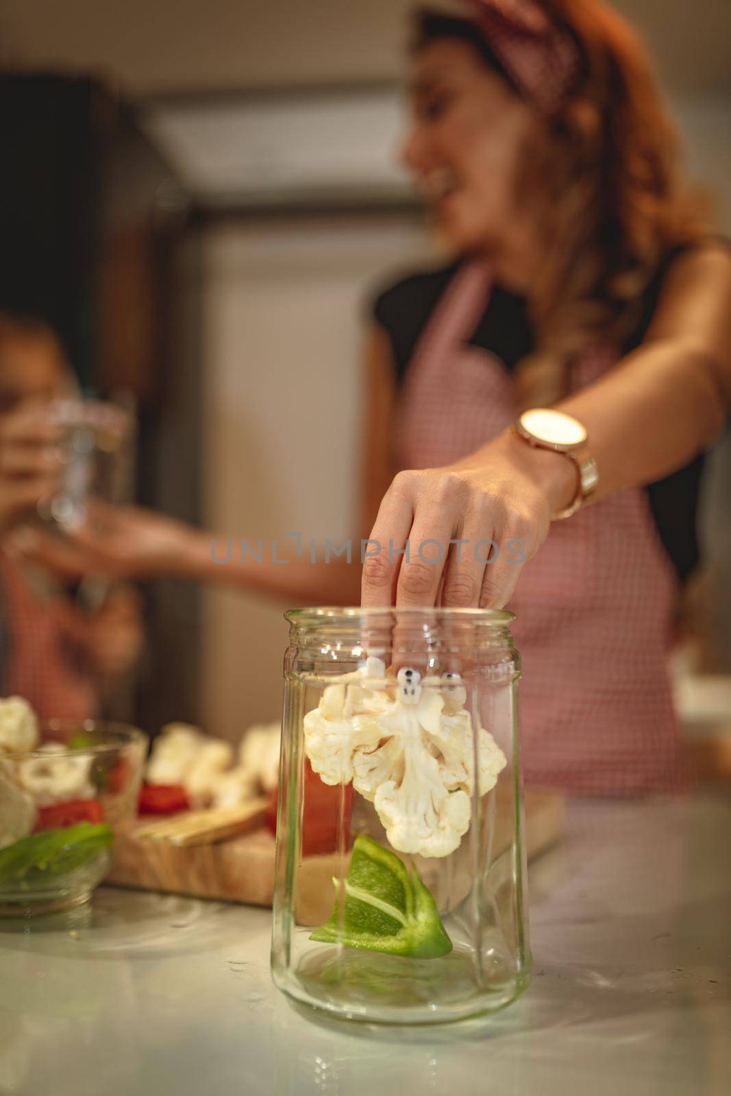 Happy young woman enjoy preparing for marinating cauliflower and making healthy meal at her home kitchen.  