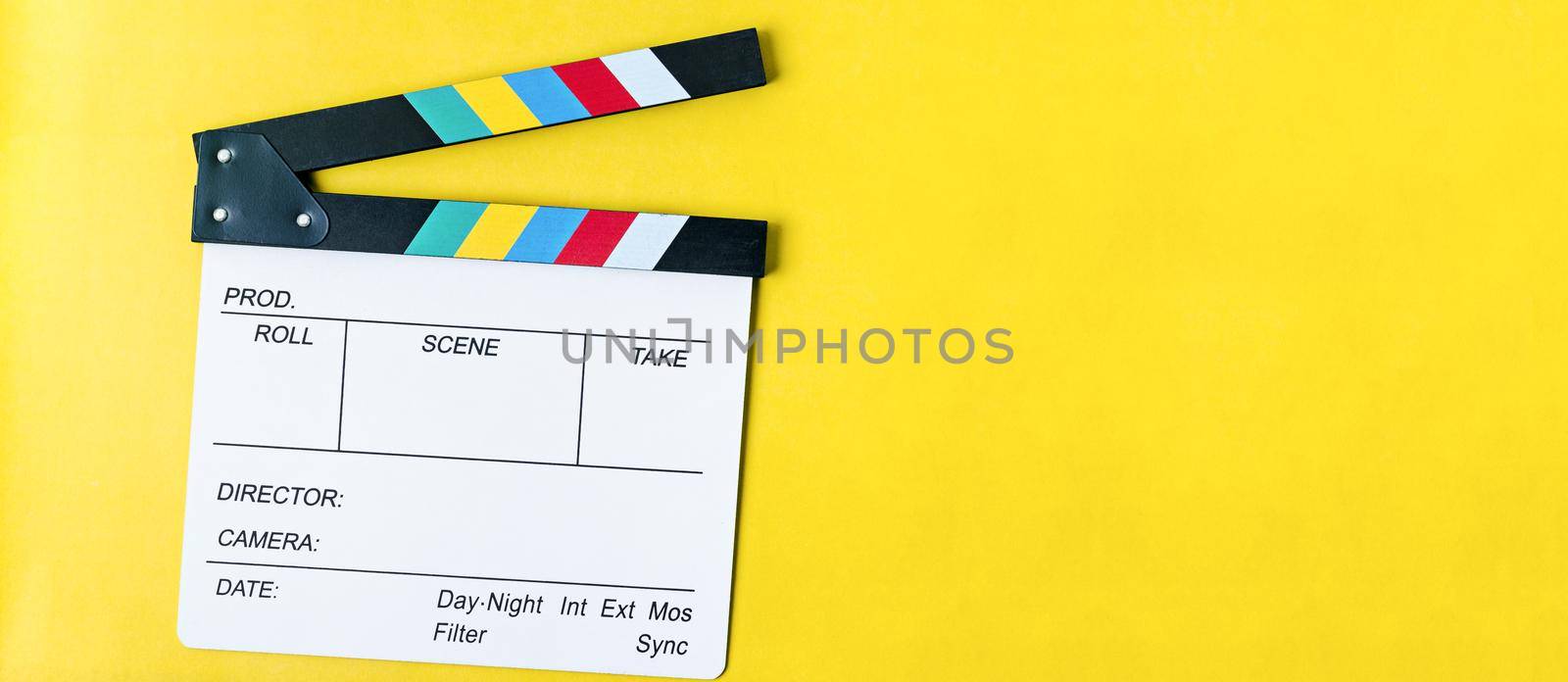 Filmmaker profession. Clapperboard on yellow background