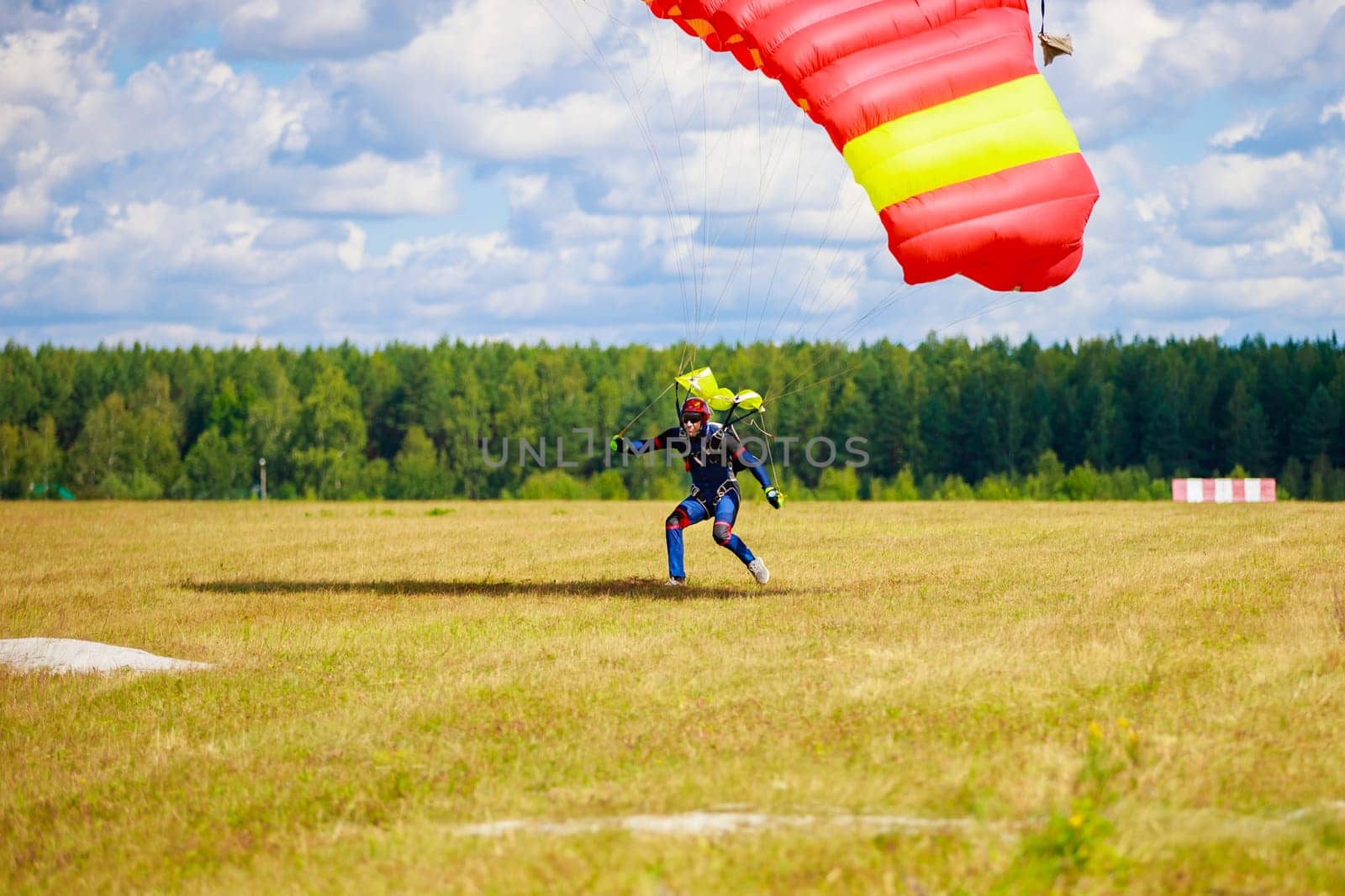 Kirzhach Russia July 22, 2023 Landing skydivers-athletes with a parachute on the ground. by Yurich32