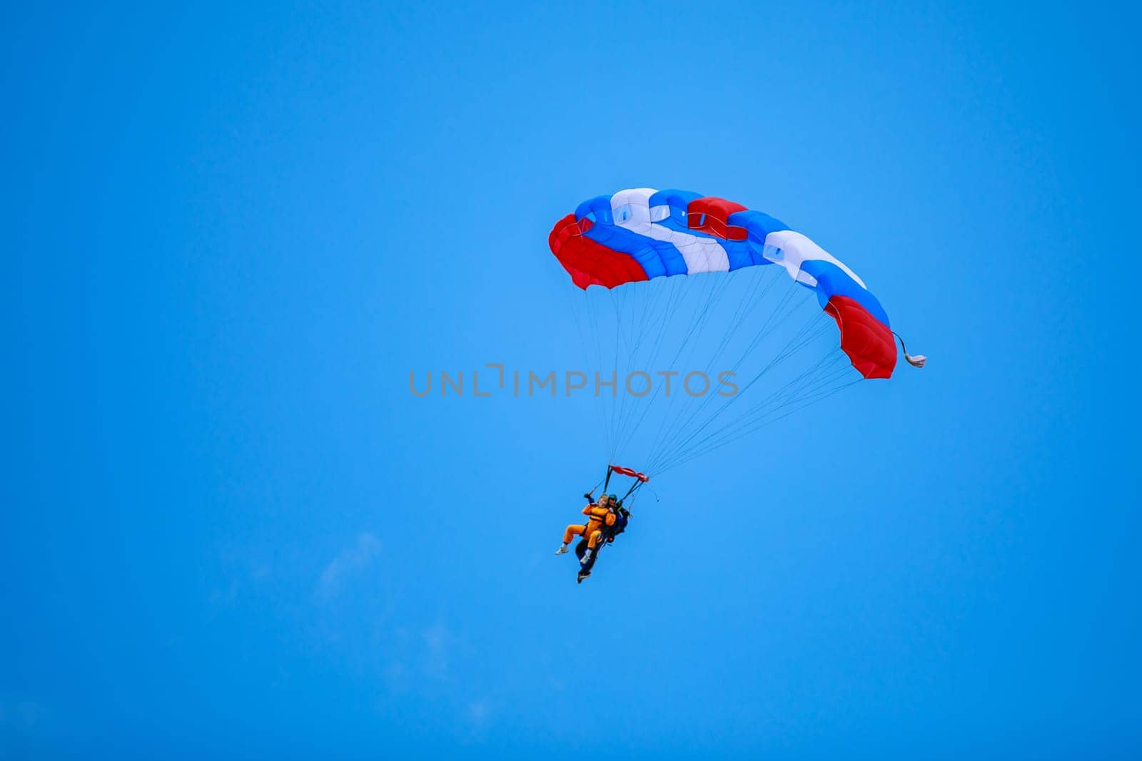 Kirzhach Russia July 22, 2023 Jump in tandem skydivers-athletes with a parachute. by Yurich32