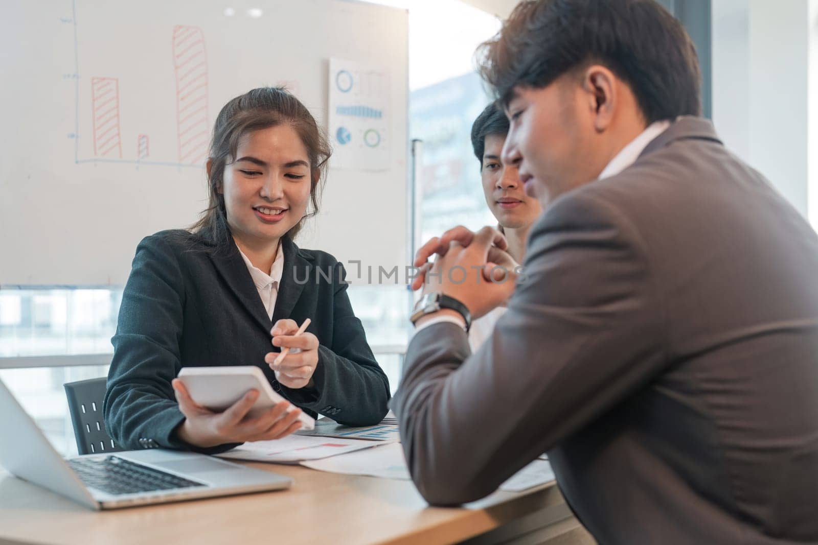 Asian business team meeting to analyze and discuss the situation on the financial report in the meeting room. Investment Consultant, Financial advisor and accounting concept.