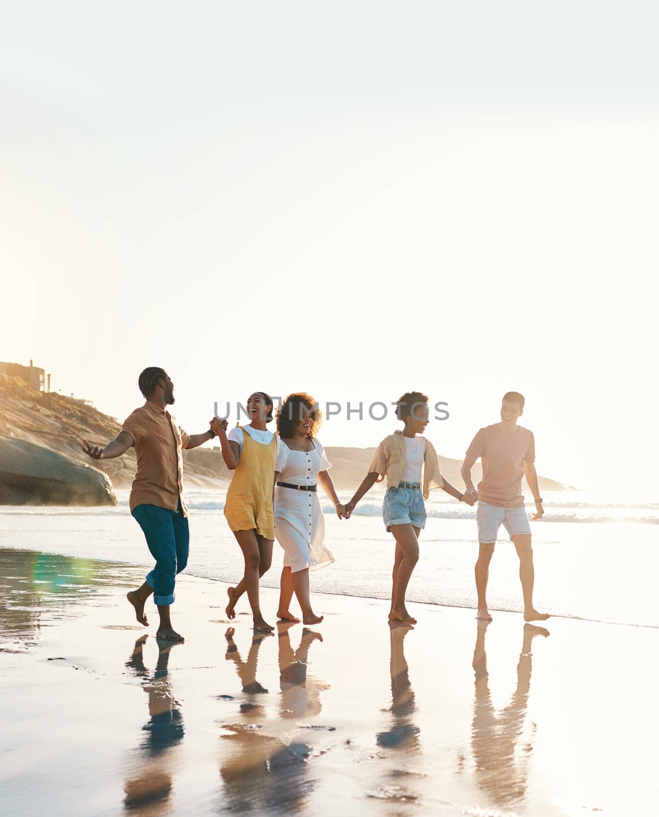 Summer, holding hands and travel with friends at beach for freedom, support and sunset. Wellness, energy and happy with group of people walking by the sea for peace, adventure and vacation mockup.
