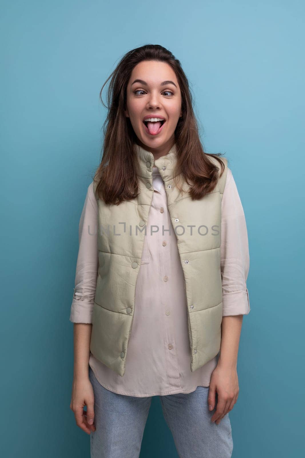 young woman with black hair makes a face and grimace.