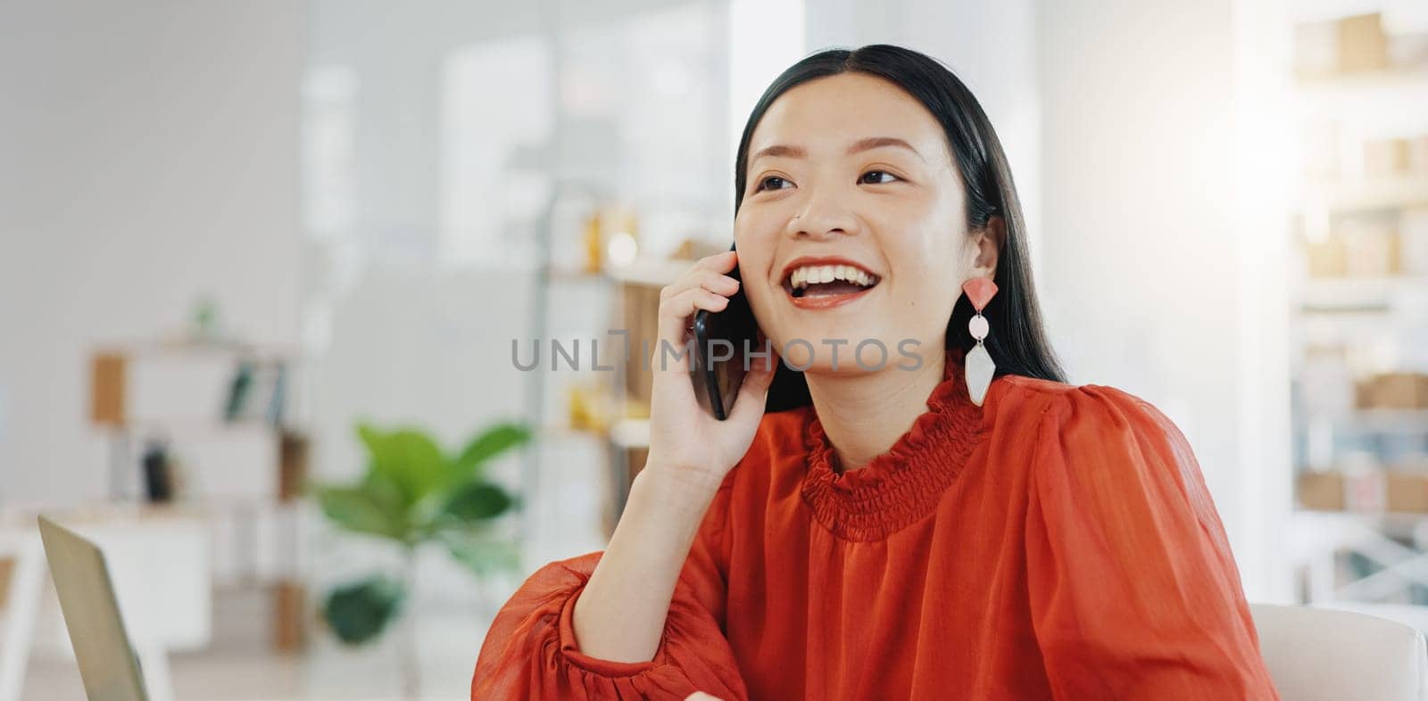Phone call, laptop and order with a designer asian woman at work in her fashion office for creative style. Contact, ecommerce and design with a female employee talking on her phone for retail by YuriArcurs