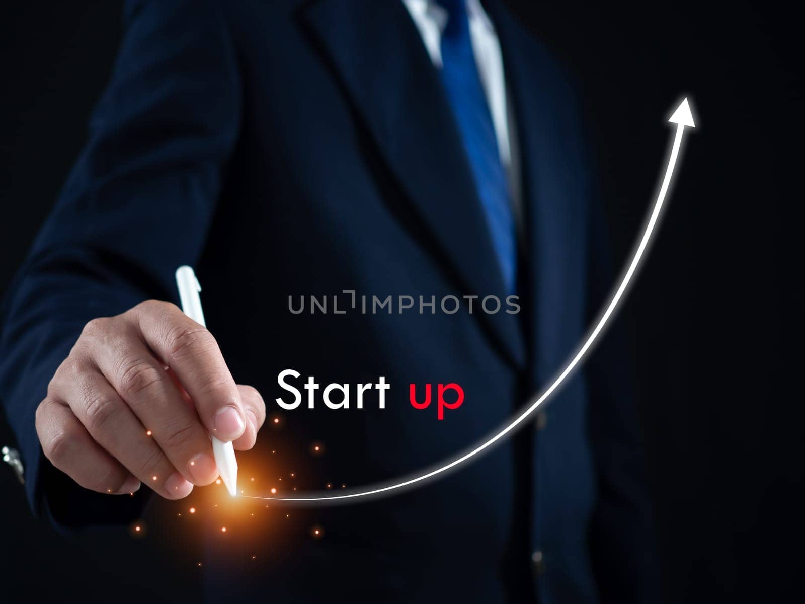 Businessman presses the pen at the starting point to start a business. Startup concept. Business concept. by Unimages2527