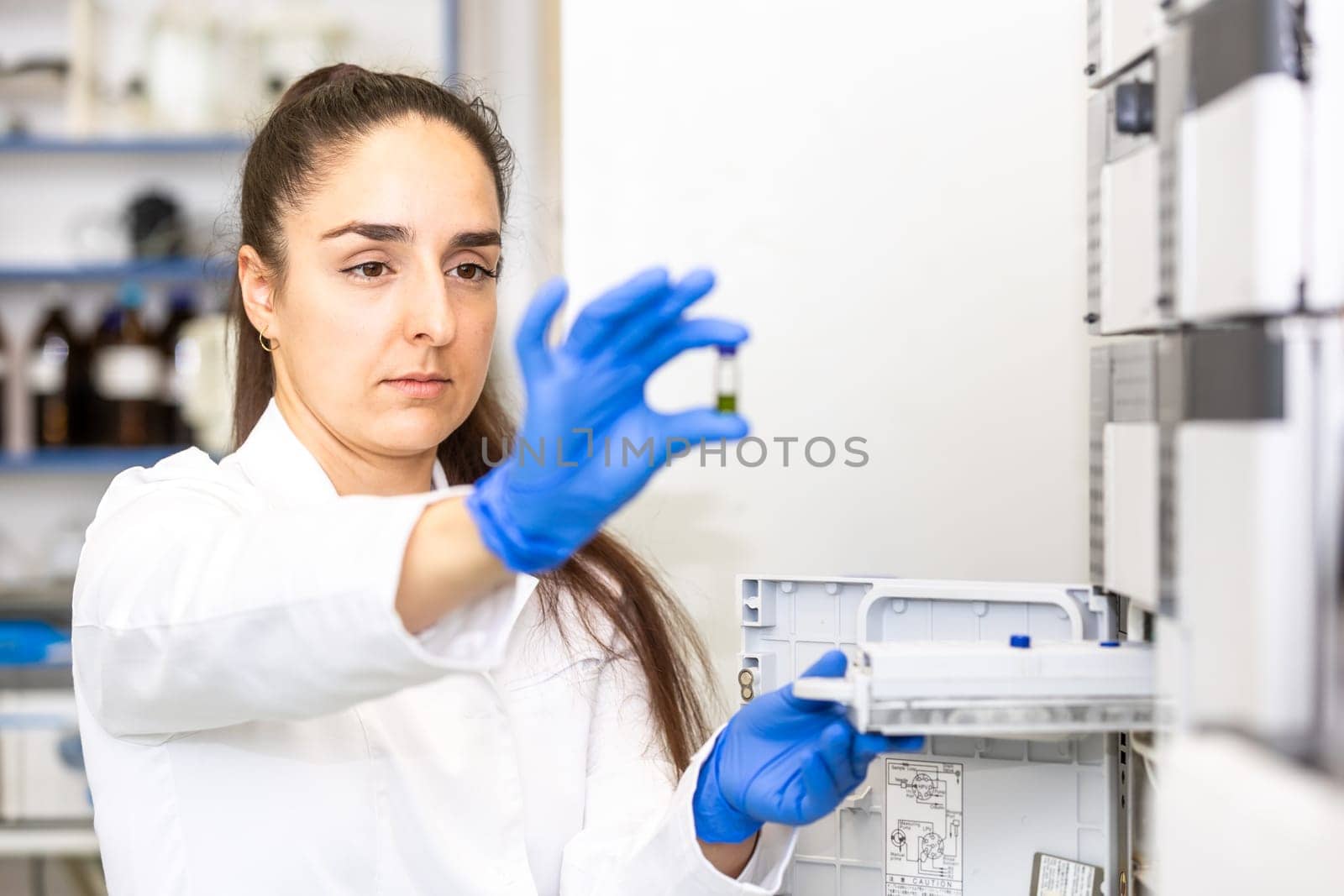 Young woman scientist in a research laboratory creating scientific experiment, laboratory concept