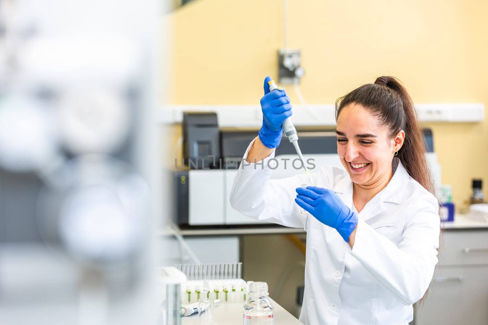Young woman scientist in a research laboratory creating scientific experiment, laboratory concept