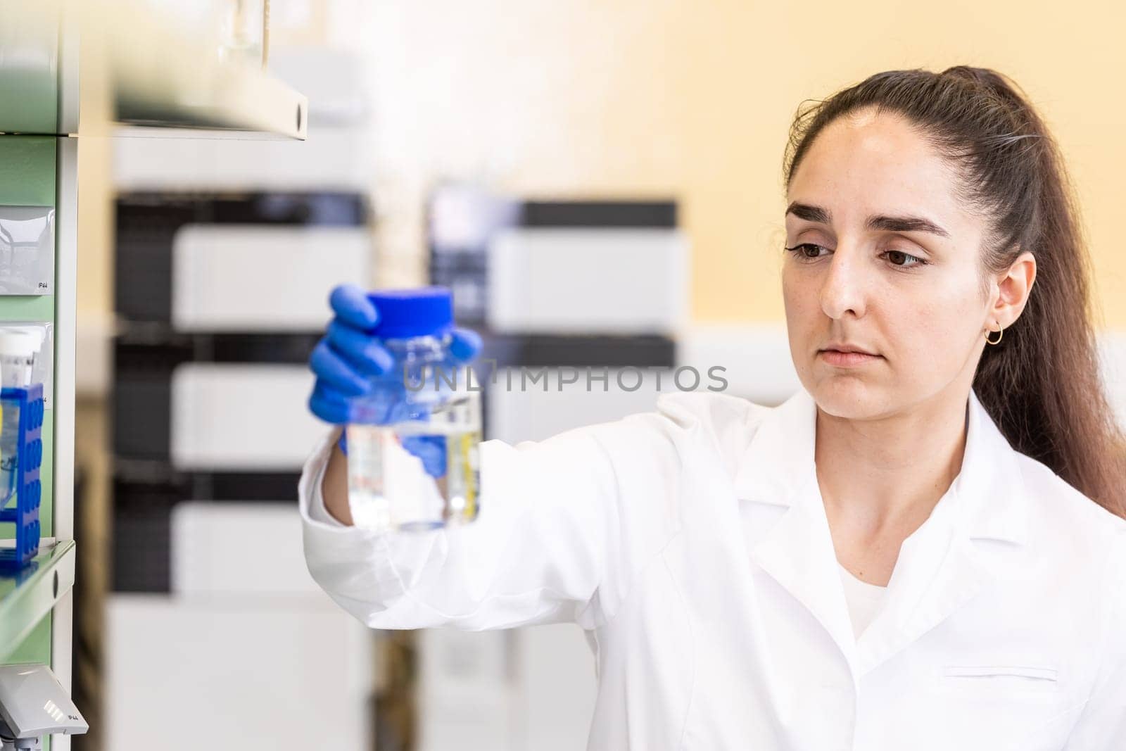 Young woman scientist in a research laboratory creating a scientific experiment, laboratory concept by Kadula