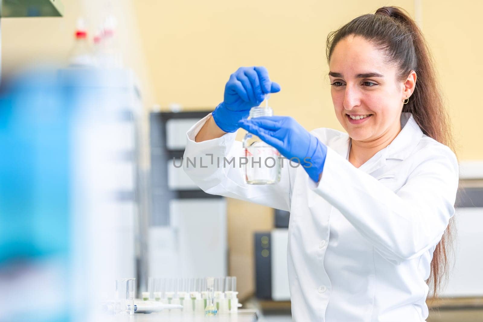 Young woman scientist in a research laboratory creating scientific experiment, laboratory concept