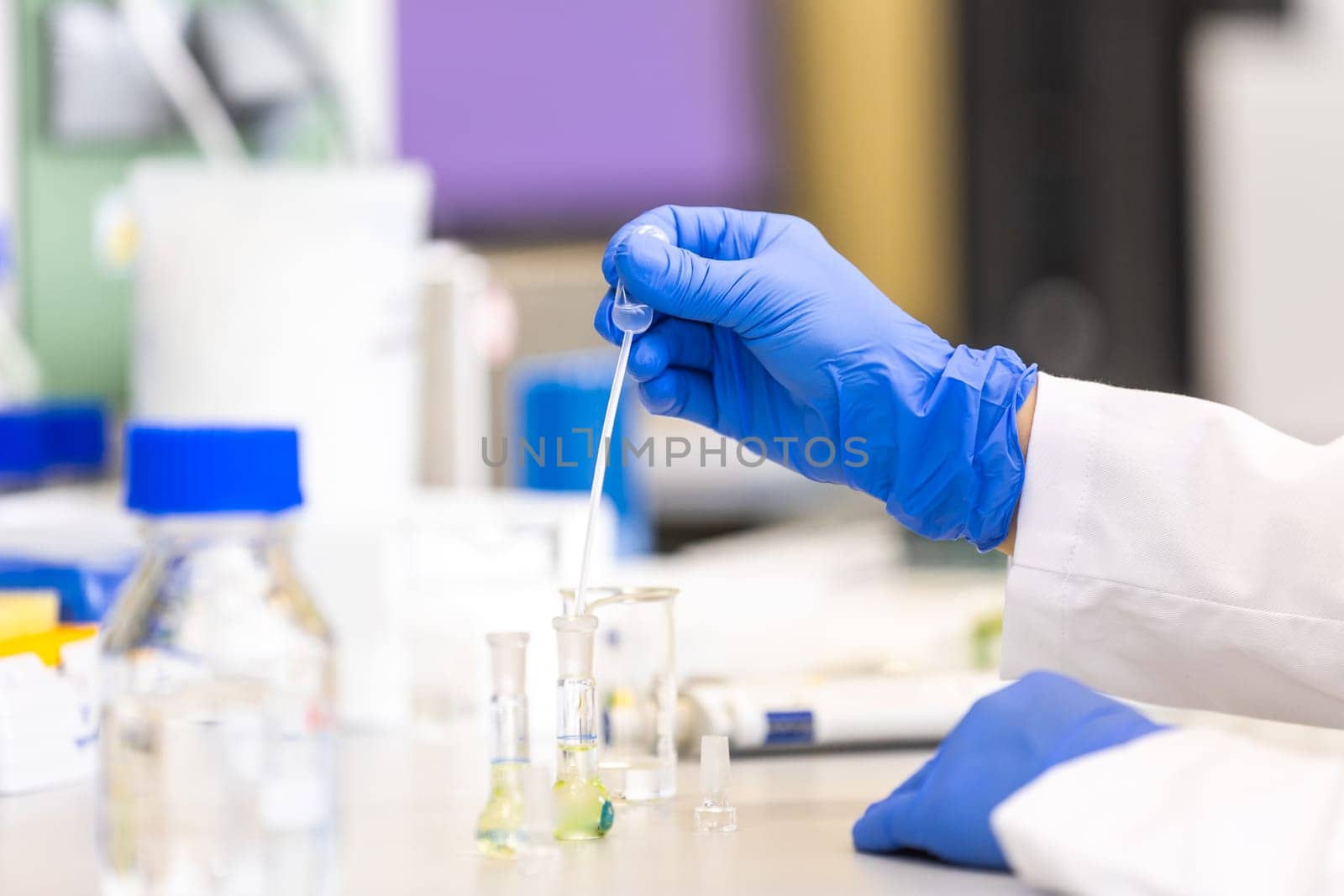 Young woman scientist in a research laboratory creating scientific experiment, laboratory concept