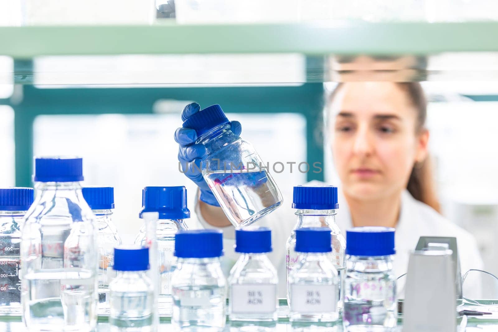 Young woman scientist in a research laboratory creating a scientific experiment, laboratory concept by Kadula