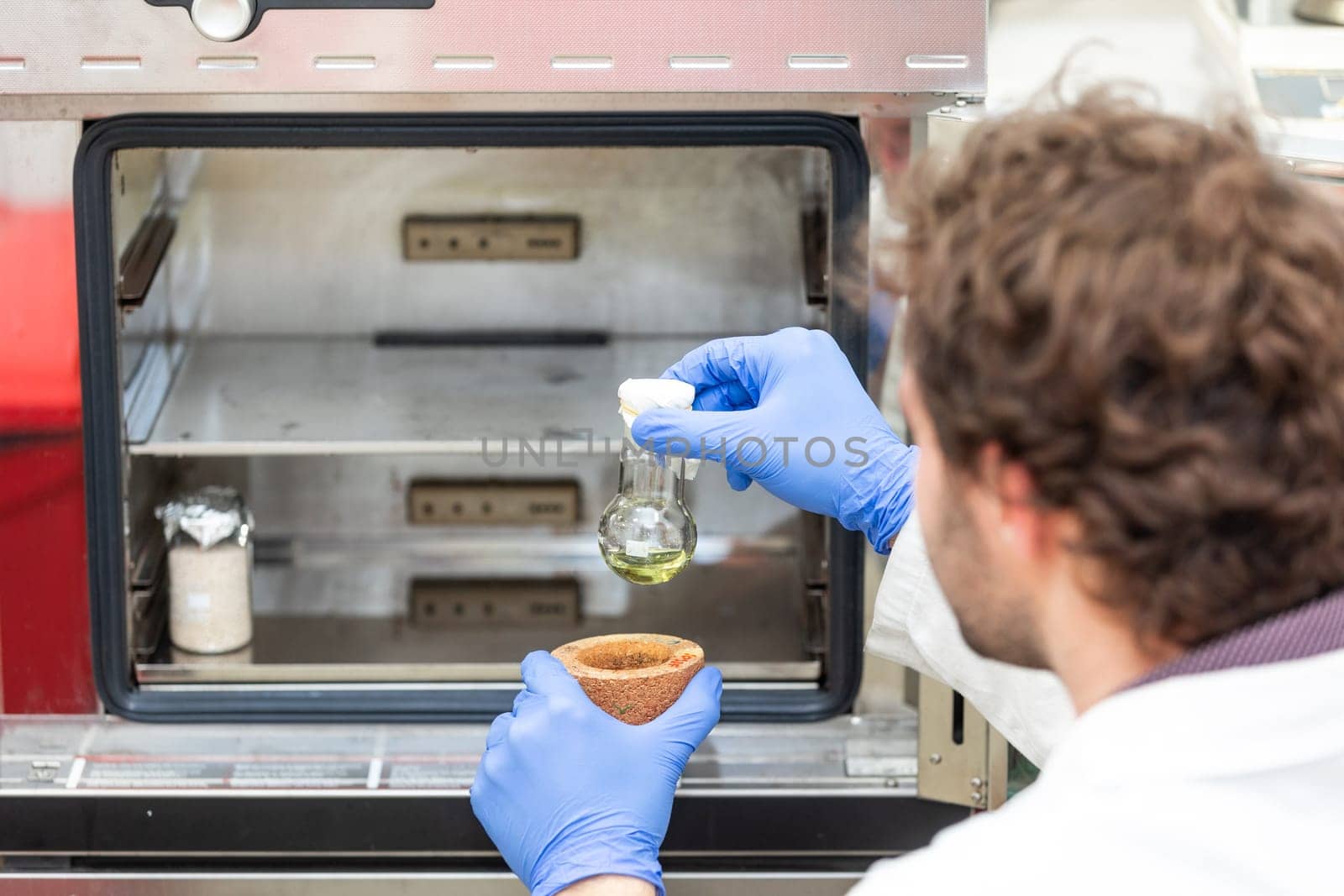 Young scientist in a research laboratory creating scientific experiment, laboratory concept