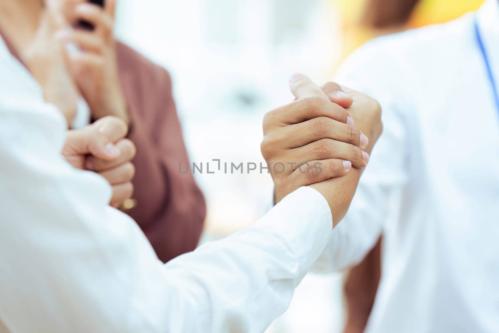 Closeup Handshake of employees after successful planning strategy marketing in the office by itchaznong