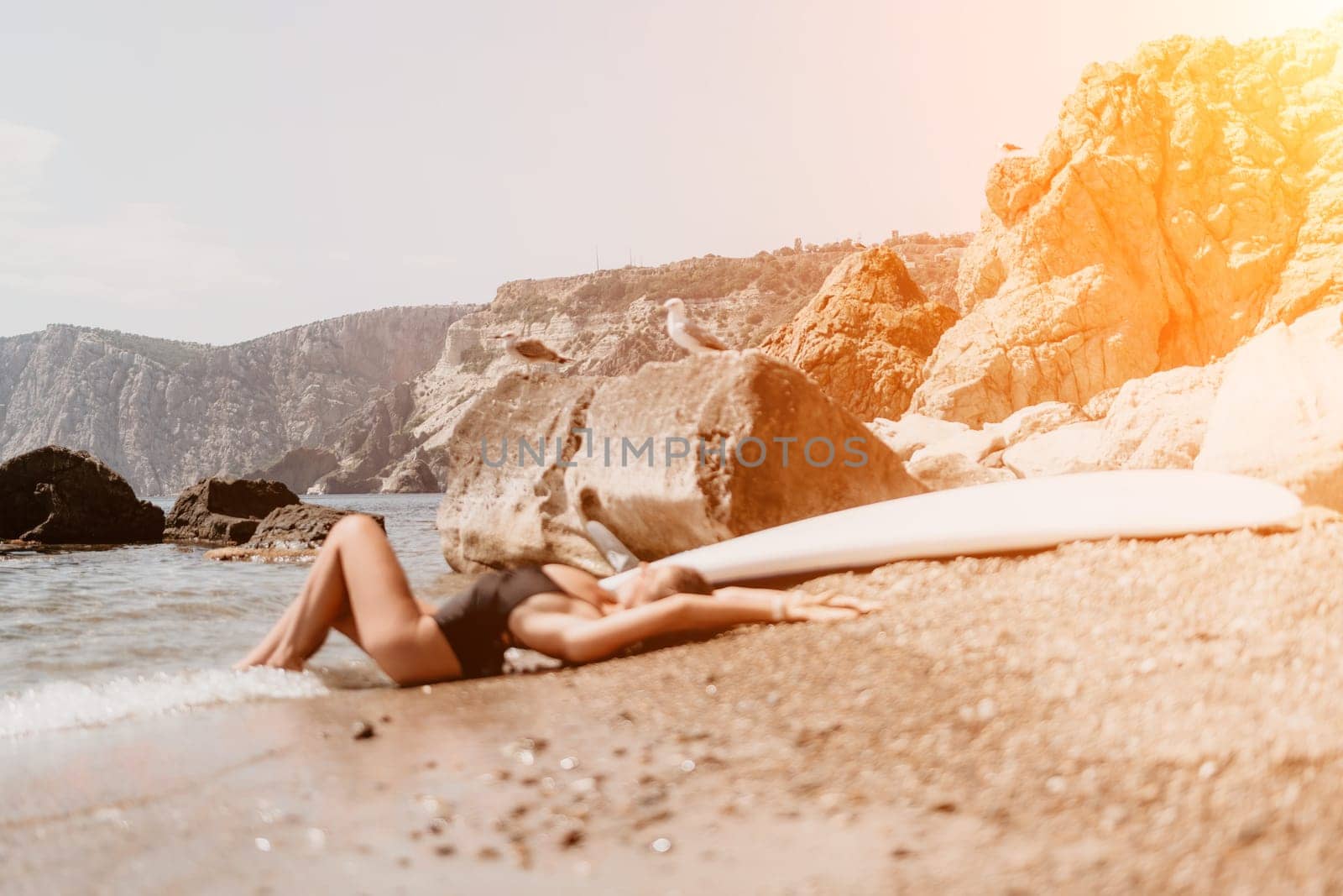 Woman summer travel sea. Happy tourist enjoy taking picture outdoors for memories. Woman traveler posing on the beach at sea surrounded by volcanic mountains, sharing travel adventure journey by panophotograph