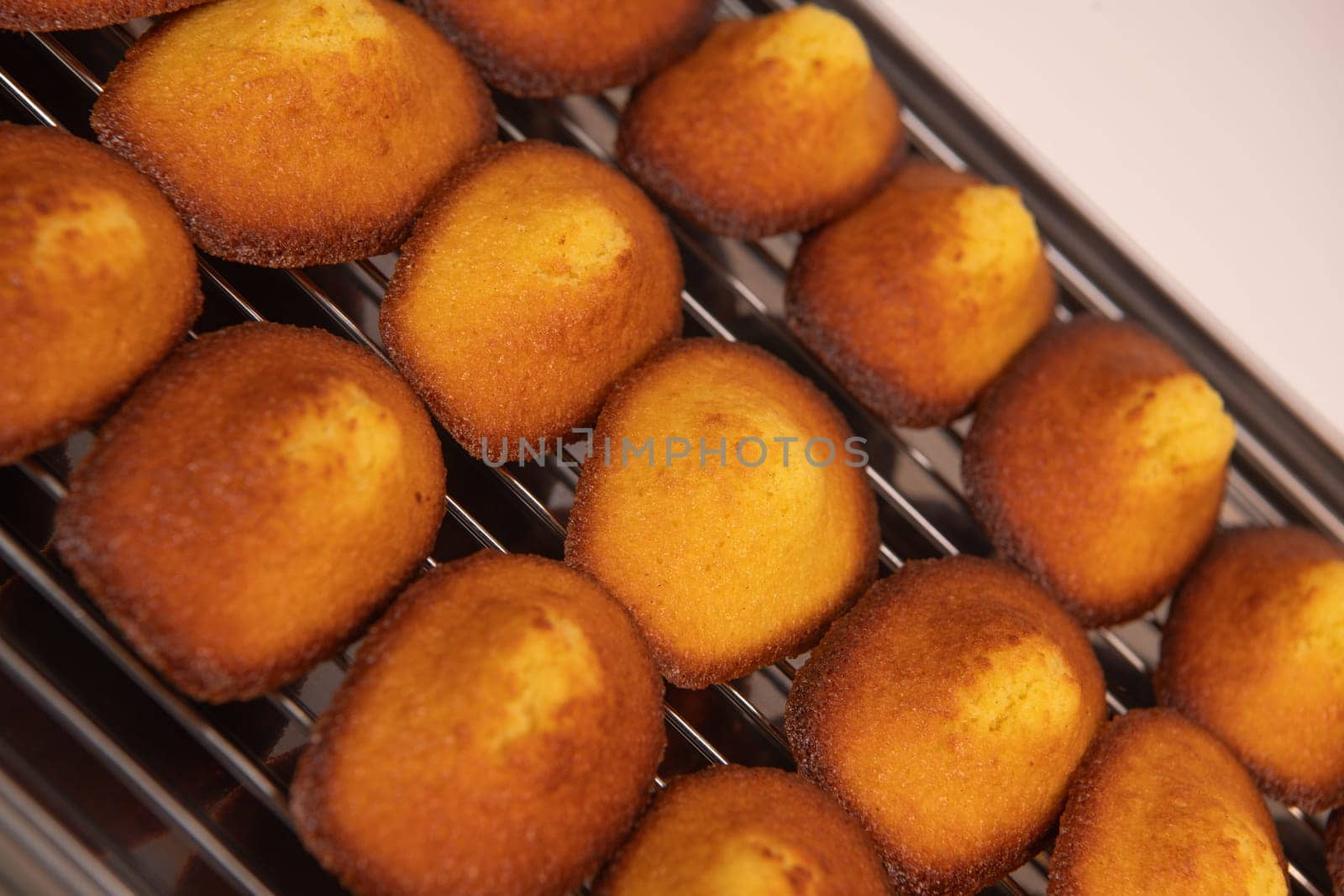 Delicious madeleine cake on on a rack after baking, flavoured with honey, lemon and vanilla, High quality 4k footage