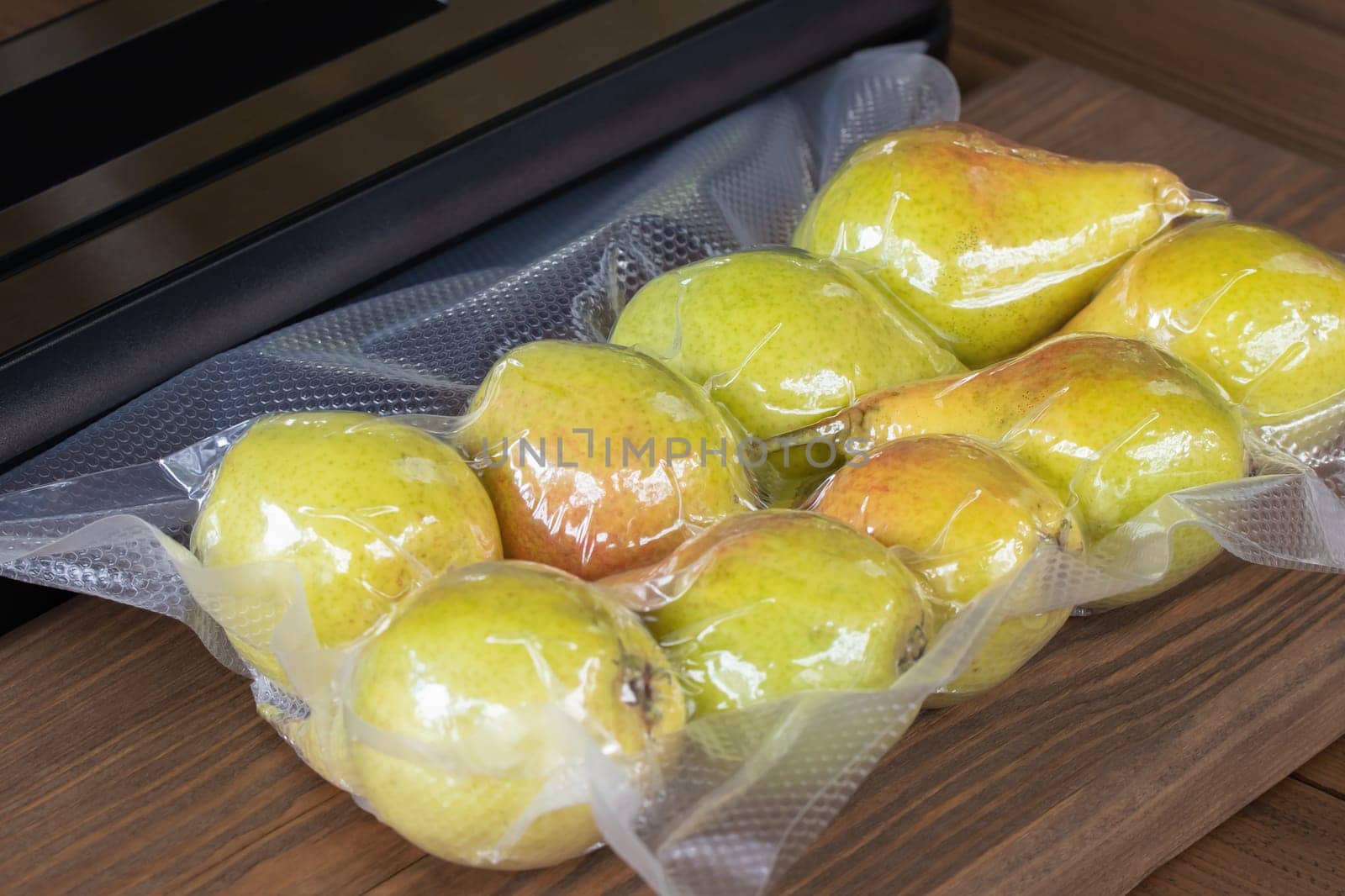 Packing fresh pears with a vacuum packer for long-term storage by galsand