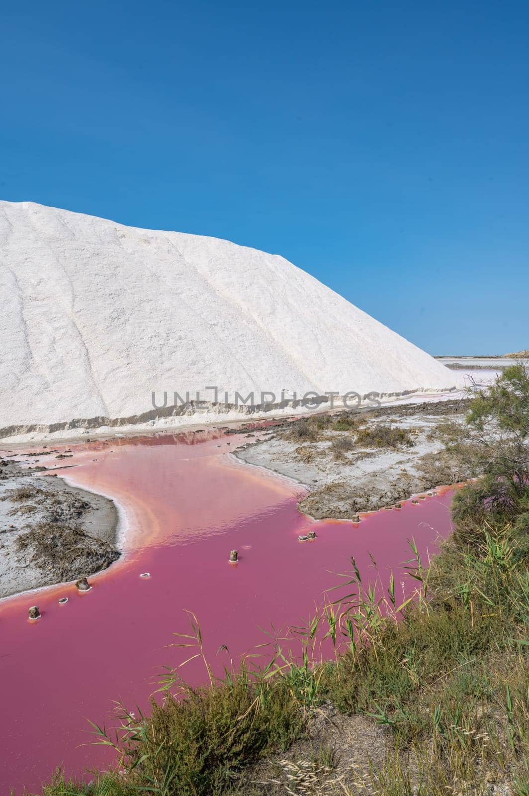 Pink Ponds In Man-made Salt Evaporation Pans In Camargue, Salin de Guiraud, France. High quality photo